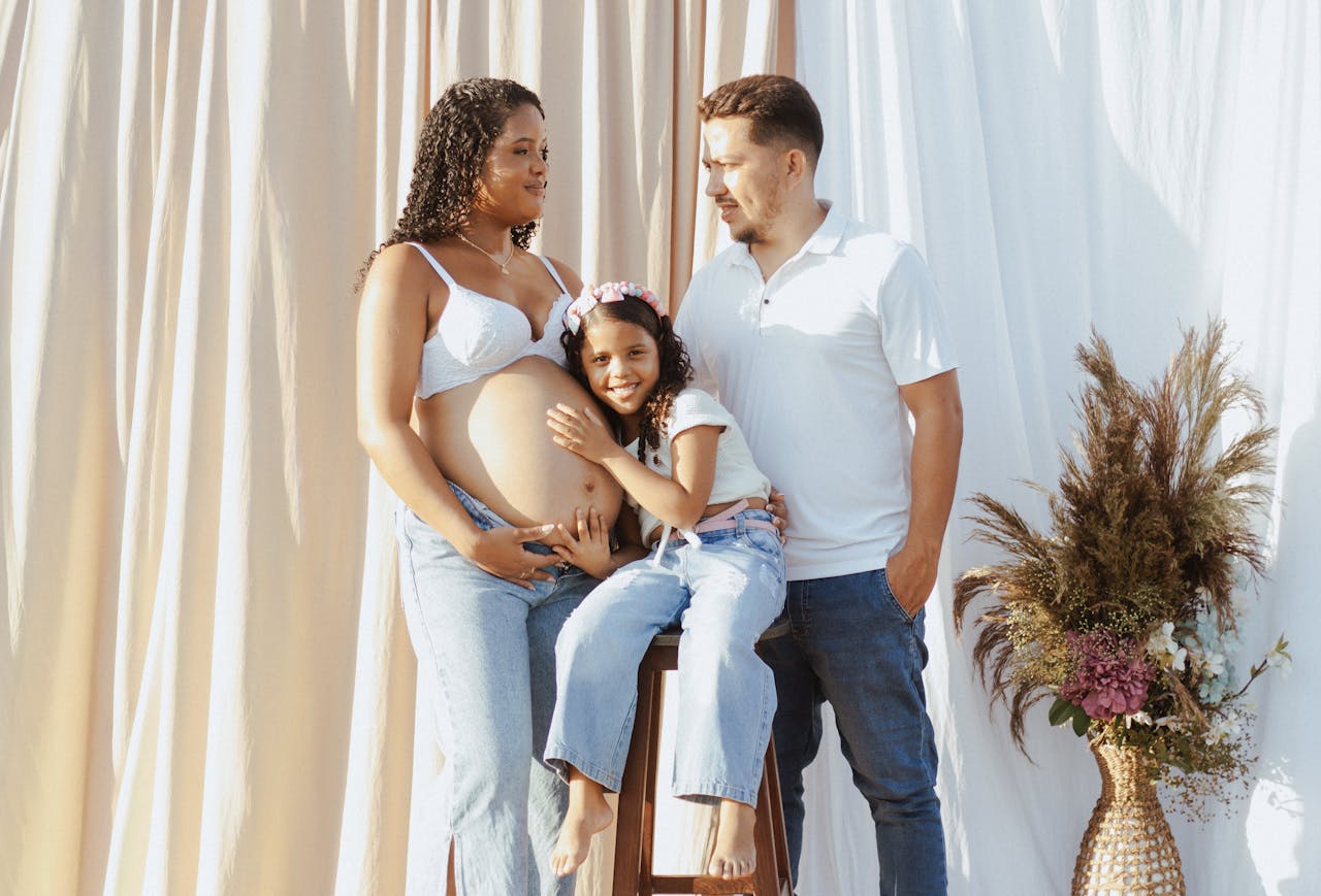 Joyful family embracing motherhood in a bright outdoor setting.