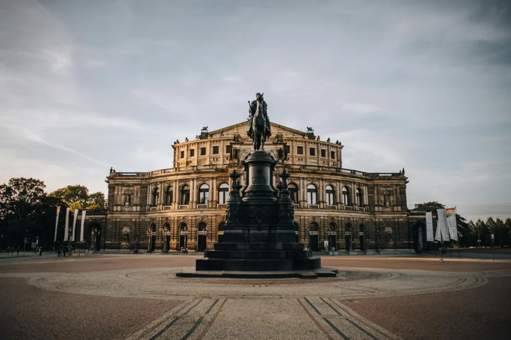 Capture of Semperoper Dresden and iconic statue at dusk, showcasing classic architecture.