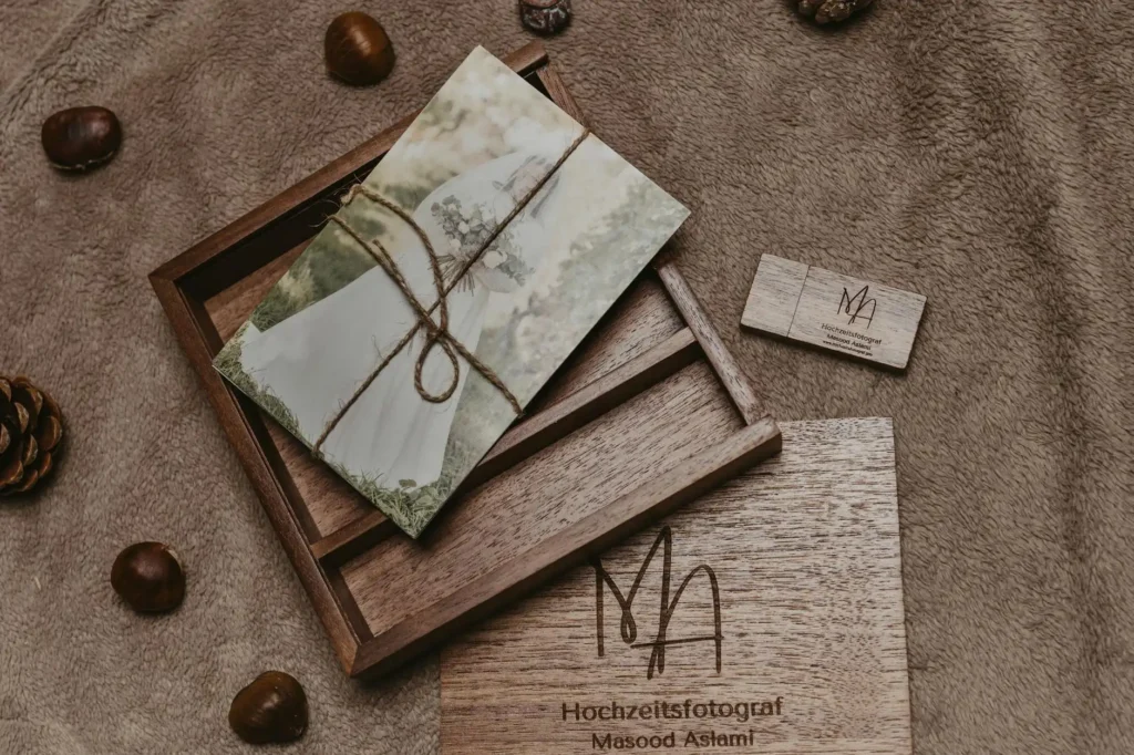 Beautiful rustic packaging for wedding photography with natural elements and wood engraving.