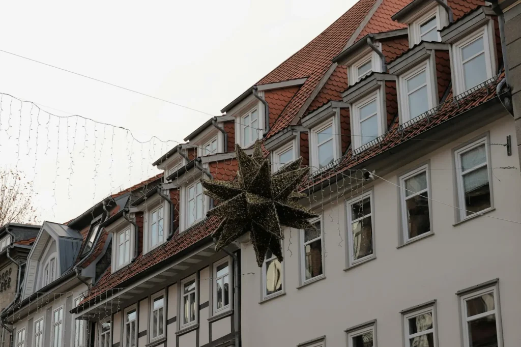 Beautiful Christmas decorations adorn classic German townhouses in Göttingen during winter time.